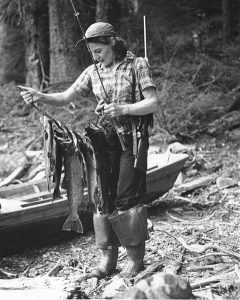 480px-Old_photo_of_woman_holding_a_fisherman_caught_fish
